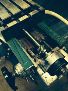 Showing the X axis ball screw, the hand wheel gearing, and the coated way (? Teflon)