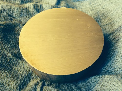 The aluminium disk straight off the band saw.  A perfect cut from a well adjusted saw.   Took about 5 minutes to make the cut, using plenty of cutting fluid and slow descent of the blade in order to avoid jamming.  