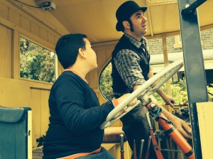 Thomas Lord in the cabin of his steam truck, giving some driving tips to Niall