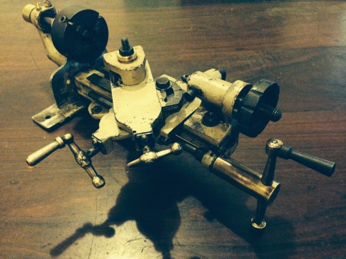 The muddy yellow-green-grey paint was revealed after an initial de-greasing.  The handles are brass.  All of the slides work, and there is no discernible wear.  The gibs are brass. One handle is broken.