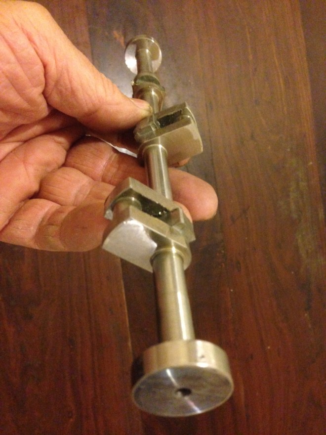  Ahuman hand for scale.  Refer back to the original lump of 50.8,, diameter stainless steel pics to see how much material has been removed, leaving the crankshaft.  I have a large amount of razor wire to dispose of, and many cuts on my hands and face.  This is mongrel material to machine and I hope to never use it again.  At least my crankshaft should not rust.