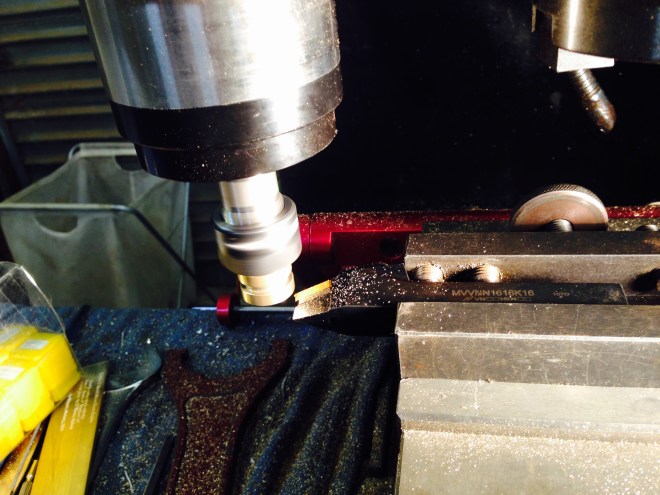 Turning pistons on a vertical mill. Not the clearest photo. It shows the high pressure piston (the smallest one) held in the collet chuck of the engraving head, being skimmed with a lathe tool which is held in the milling vise. It worked very well indeed!