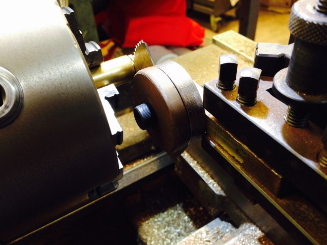 A broken slitting blade, held in a shop made holder.  Normally I use it under power, but in this case, the part was held fairly tenuously, so I turned the lathe spindle by hand.  It worked perfectly!