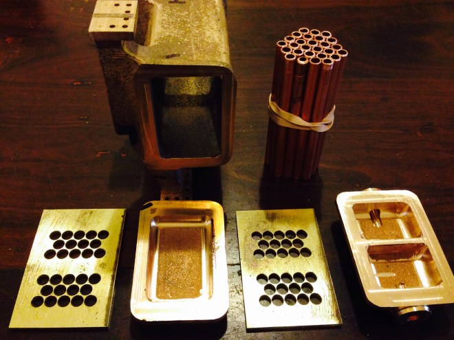 The condenser components.  There are 28 tubes, to be soldered into the holey brass plates.