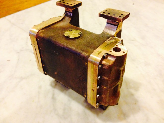 The condenser covers are attached to the condenser body with BA7 screws.  The 4 inlets/outlets are drilled, surface machined, and screw holes tapped ready for the pipes.