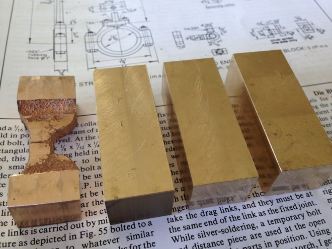 Six valve rod "yokes" need to be made, but there was only one casting, so I have decided to make them all from bar stock.  The dimensioned bar stock (10x16x55mm) is seen here, with the "Model Engineer" article on the subject underneath.