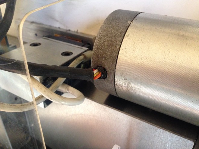 The before.  This the Z axis stepper motor on my Boxford CNC lathe.  The lathe is 30 years old, so it is not too surprising that the plastic cable coating is becoming stiff and peeling back.